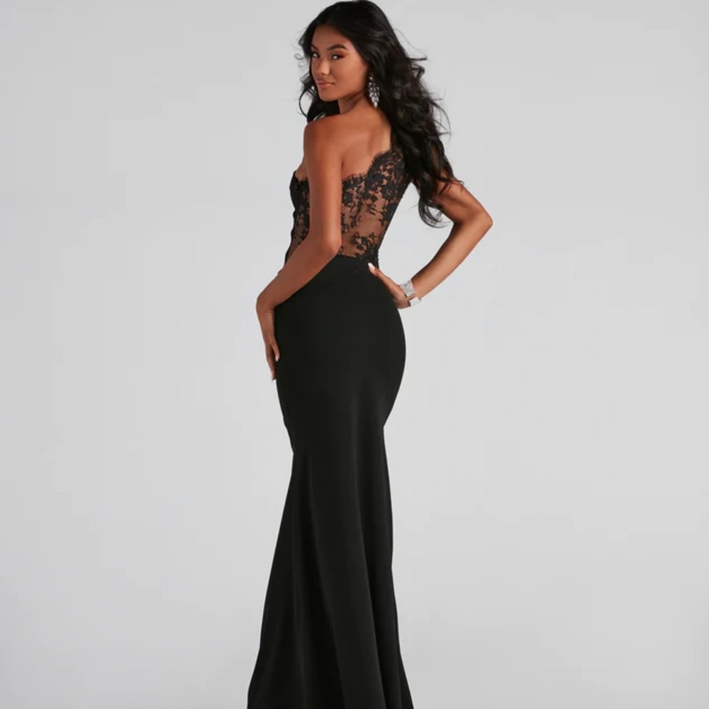 Black one shoulder gown. Size large, dress size 10-12. New with tag never worn.